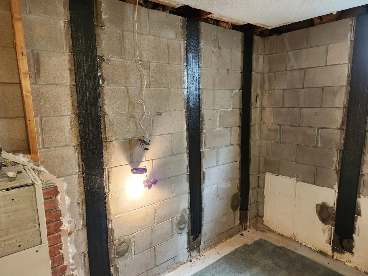 Carbon fibre straps bonded to a bowed block foundation wall to stop further movement