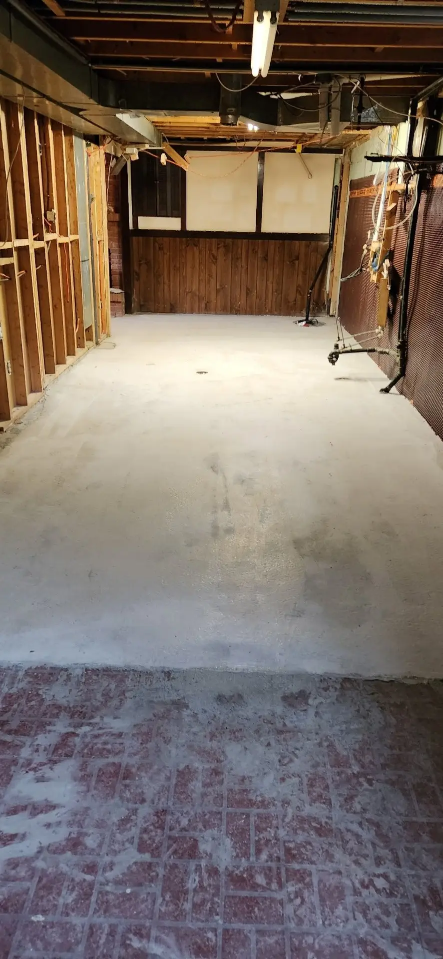 Finished lowered basement with full-height ceilings and a new floor