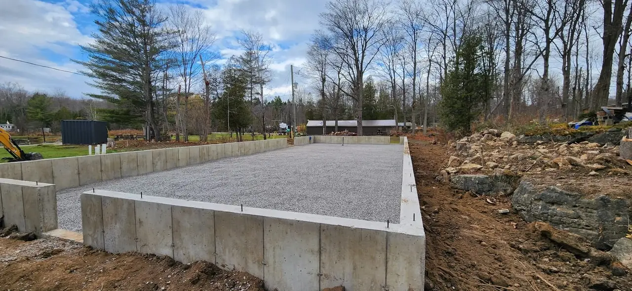 New poured concrete foundation with a gravel base, formed and poured by AVH Foundations on a rural lot near Hamilton