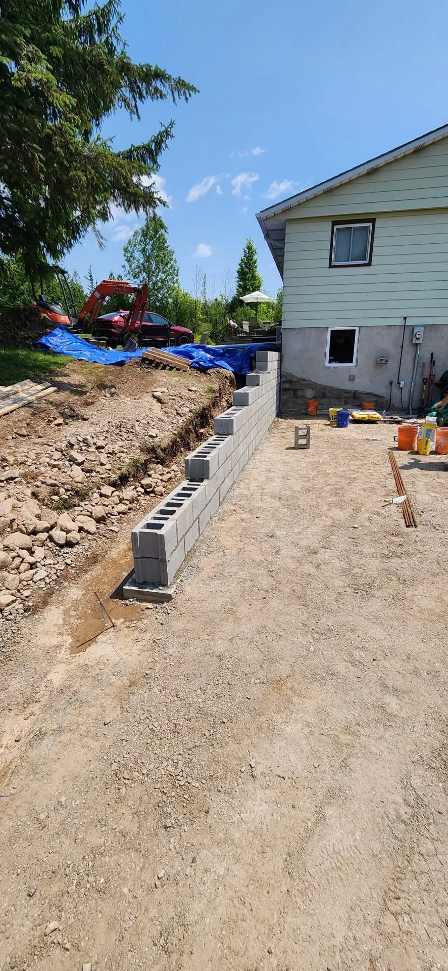 Excavated trench and new block wall for a walkout basement entrance