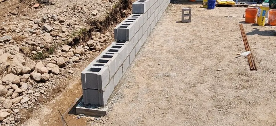 Excavated trench and new block wall for a walkout basement entrance