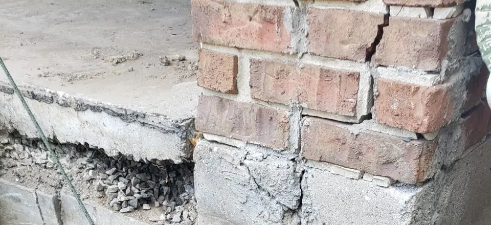 Block foundation corner excavated for repair and waterproofing